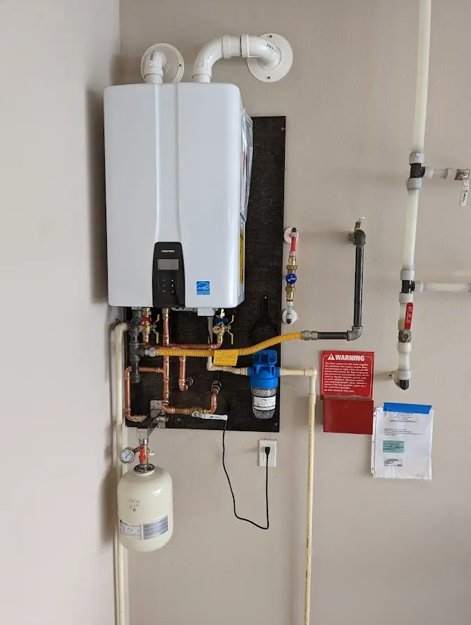 Professional plumber installing copper piping in a El Jebel home